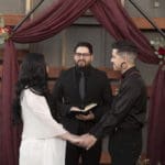 Wedding Couple exchanging vows in charming wedding venue