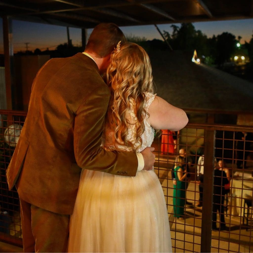 Couple gazing at sunset in Fall Wedding Venue Rooftop Balcony