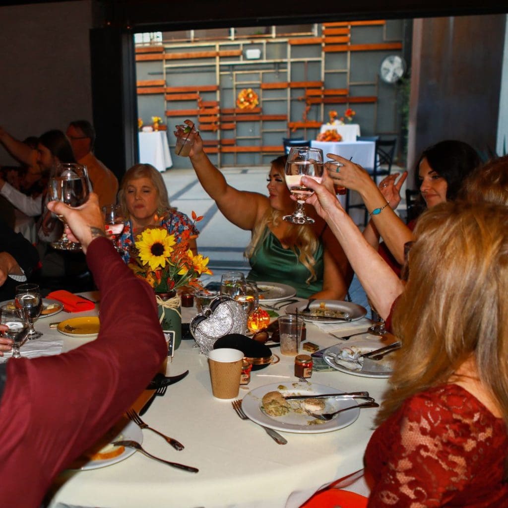 Wedding Reception guests toasting in Fall Wedding Venue